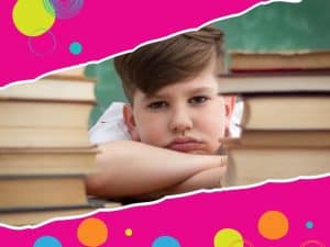 A frustrated boy sitting between books, highlighting how to help a child struggling with reading challenges.