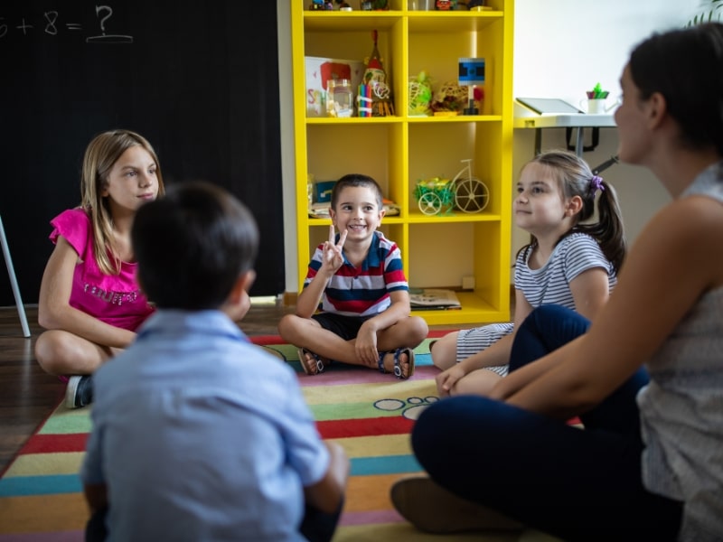 Happy children learning and playing in a colourful classroom, exploring educational programs for kids.