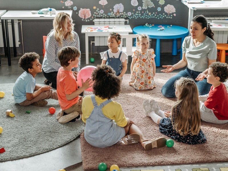 A group of children engaged in learning activities at a daycare, highlighting the importance of early childhood education.