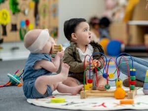 Babies engaging with sensory toys and activities for infants in a daycare, fostering early cognitive and social skills.