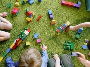 Toddlers engaged in play-based learning, highlighting the importance of play based learning for development.