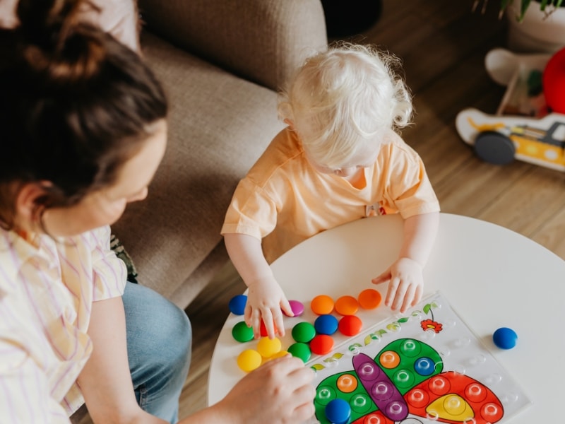 Children exploring with blocks, highlighting the importance of play-based learning for development.