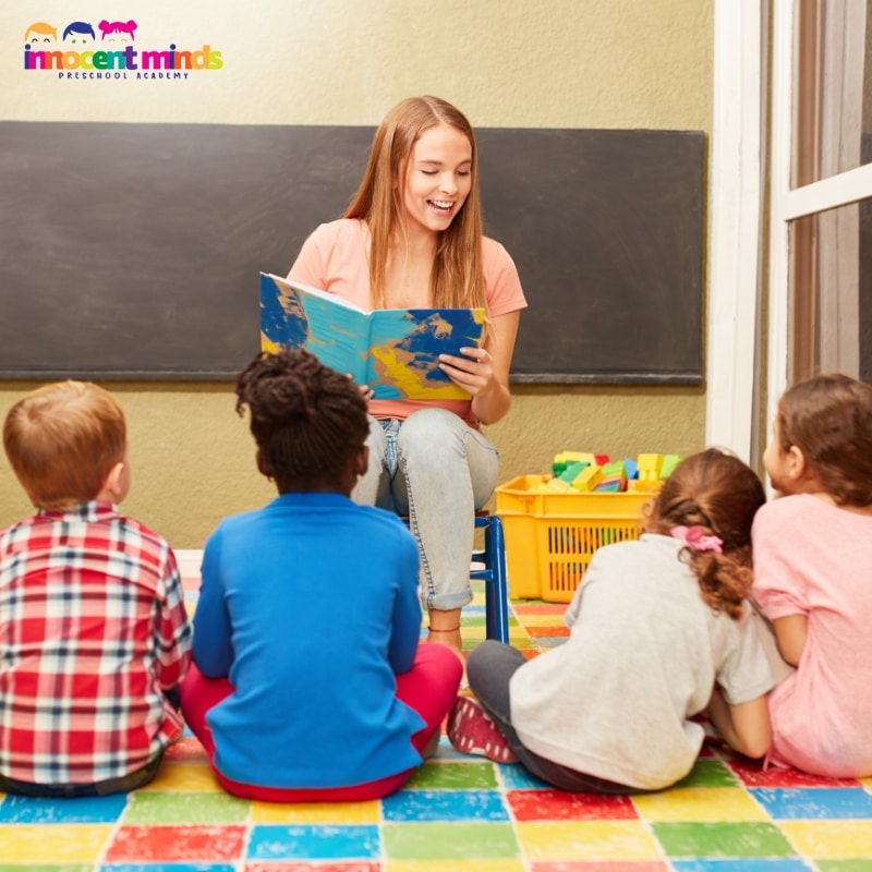 Teacher reading to children in a classroom during Arabic Classes for Kids with interactive learning activities.