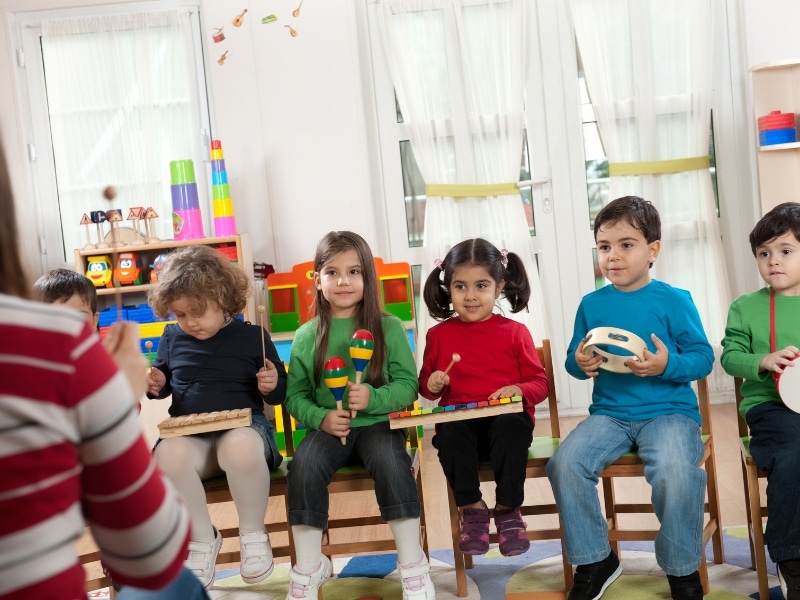 Preschoolers use musical instruments during a school readiness test group session.