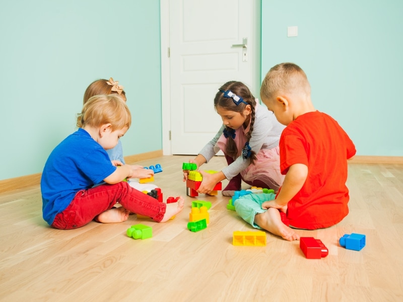 Children playing with building blocks as part of a school readiness test activity.